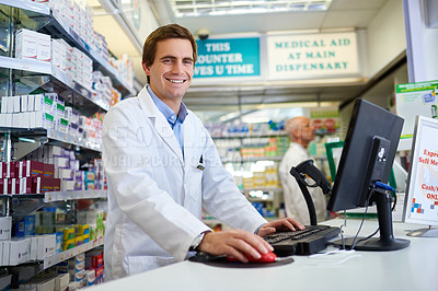 Buy stock photo Portrait of a young pharmacist working on a computer in a chemist