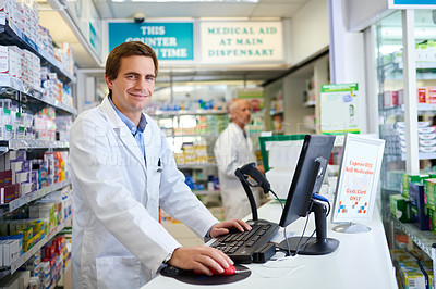 Buy stock photo Portrait of a young pharmacist working on a computer in a chemist