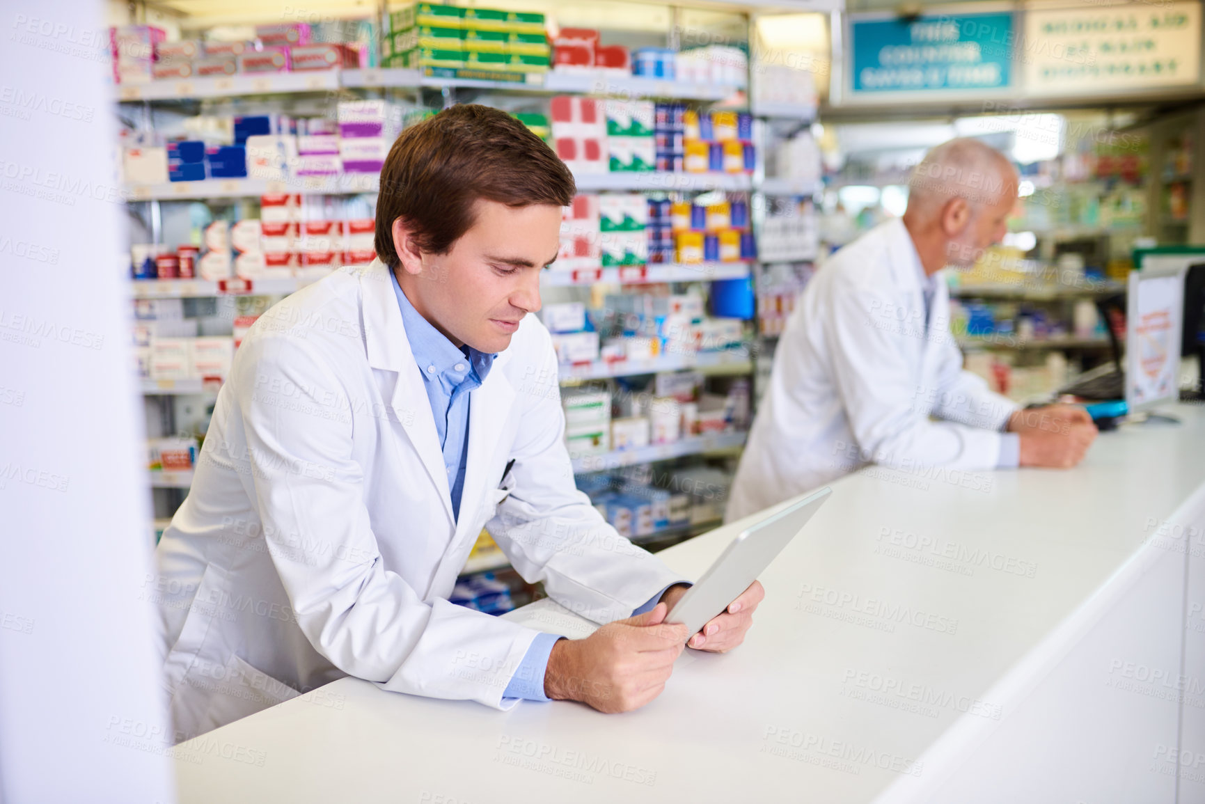 Buy stock photo Shop, pharmacist and man on tablet for healthcare, service or medicine for telehealth. Pharmacy, reading and medical professional on technology in drugstore to check inventory, sales and online email