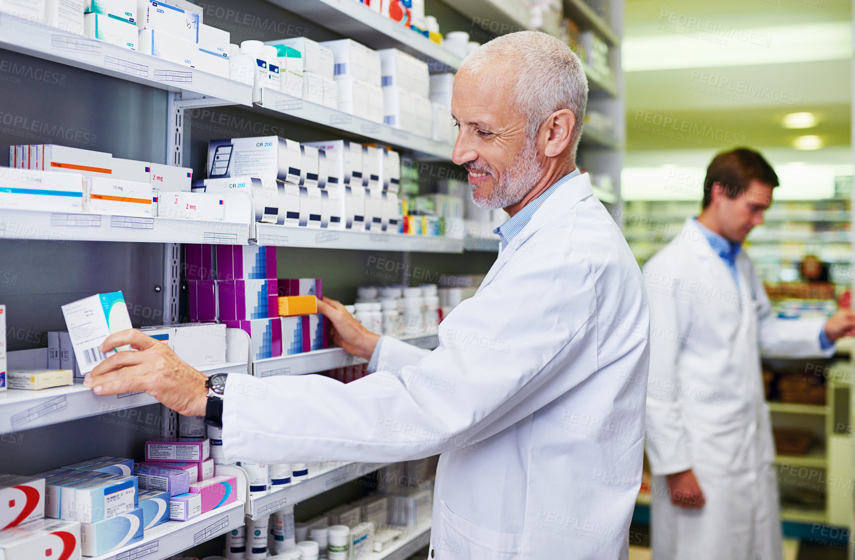 Buy stock photo Shot of a mature pharmacist doing inventory in a pharmacy