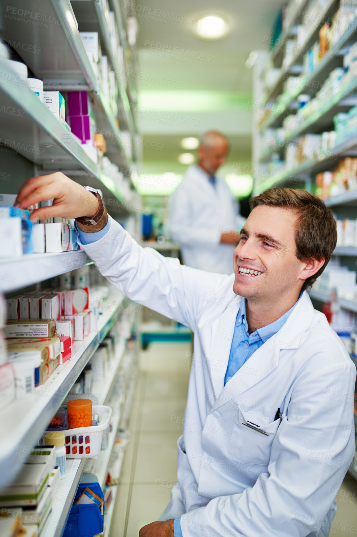 Buy stock photo Shot of a young pharmacist doing inventory in a pharmacy