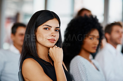 Buy stock photo Cropped portrait of an attractive young businesswoman sitting in the conference room during a seminar