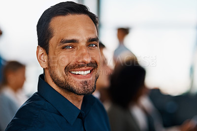 Buy stock photo Cropped portrait of a handsome young businessman sitting in the conference room during a seminar