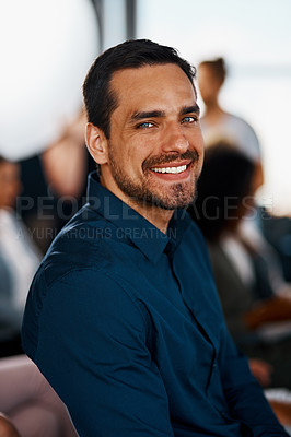 Buy stock photo Cropped portrait of a handsome young businessman sitting in the conference room during a seminar