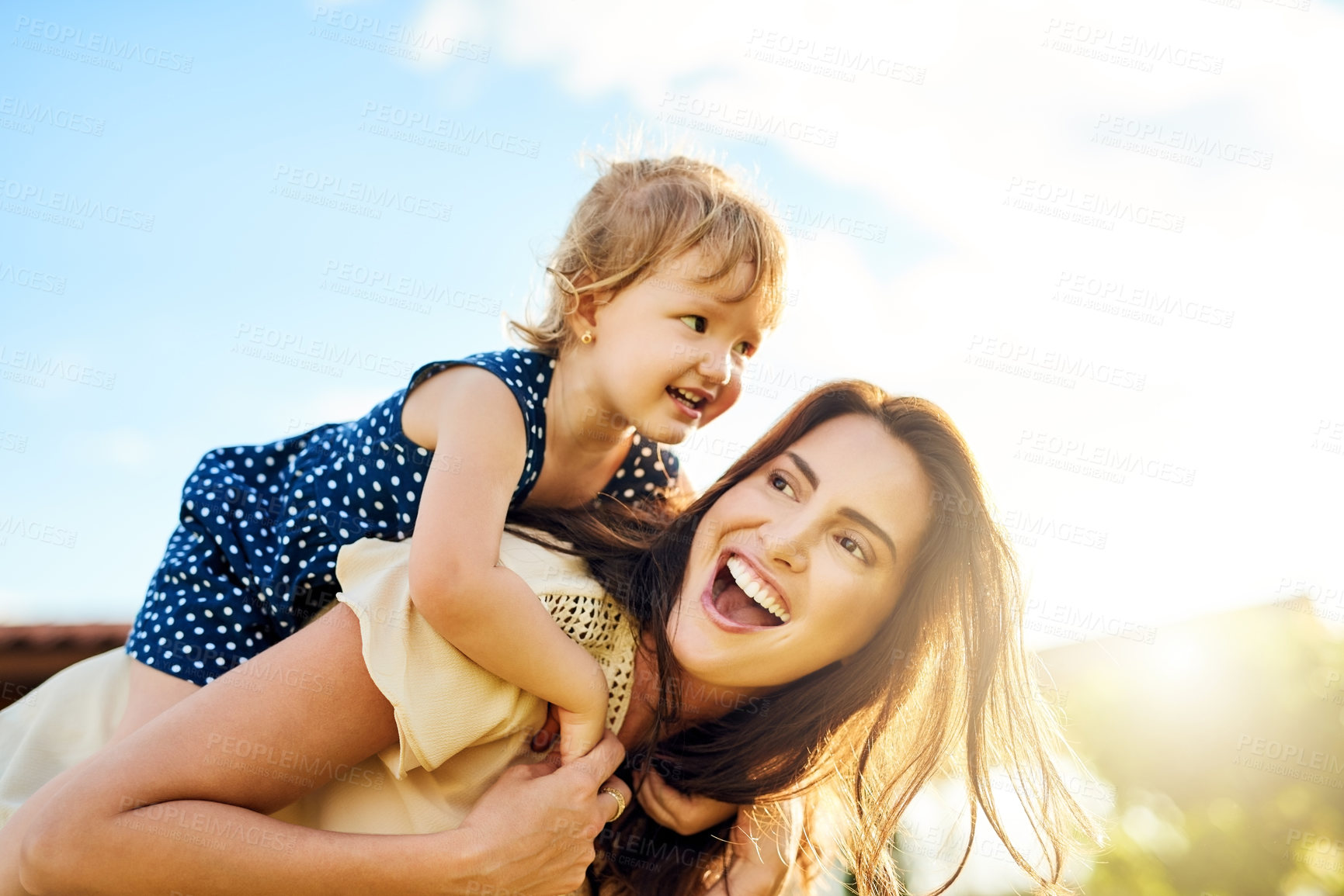 Buy stock photo Shot of a mother bonding with her adorable little daughter outdoors