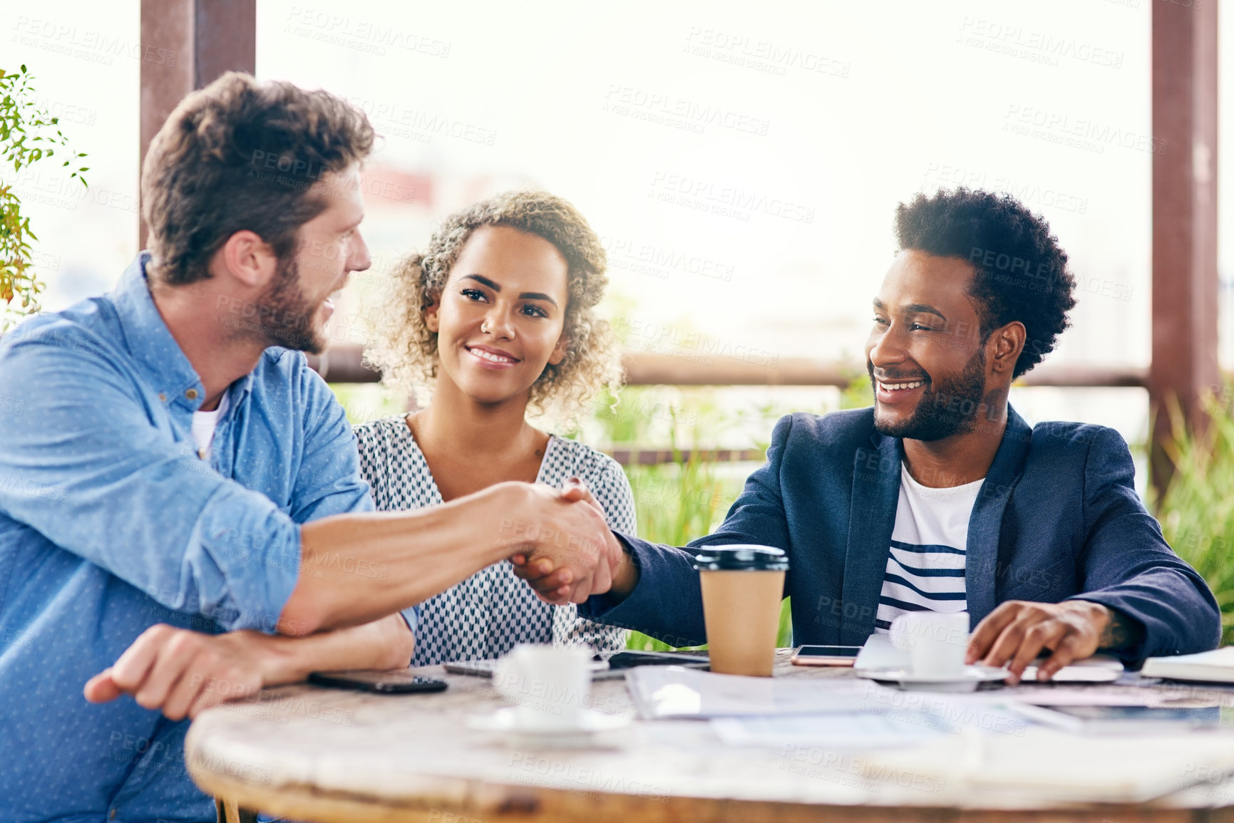 Buy stock photo Happy, business people and meeting with handshake for deal, agreement or teamwork at outdoor cafe. Businessmen, group or employees shaking hands for company mission, b2b or partnership at coffee shop