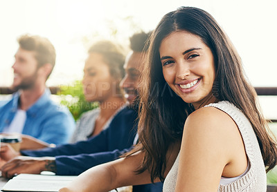 Buy stock photo Portrait of a young businesswoman having a meeting with her colleagues outdoors
