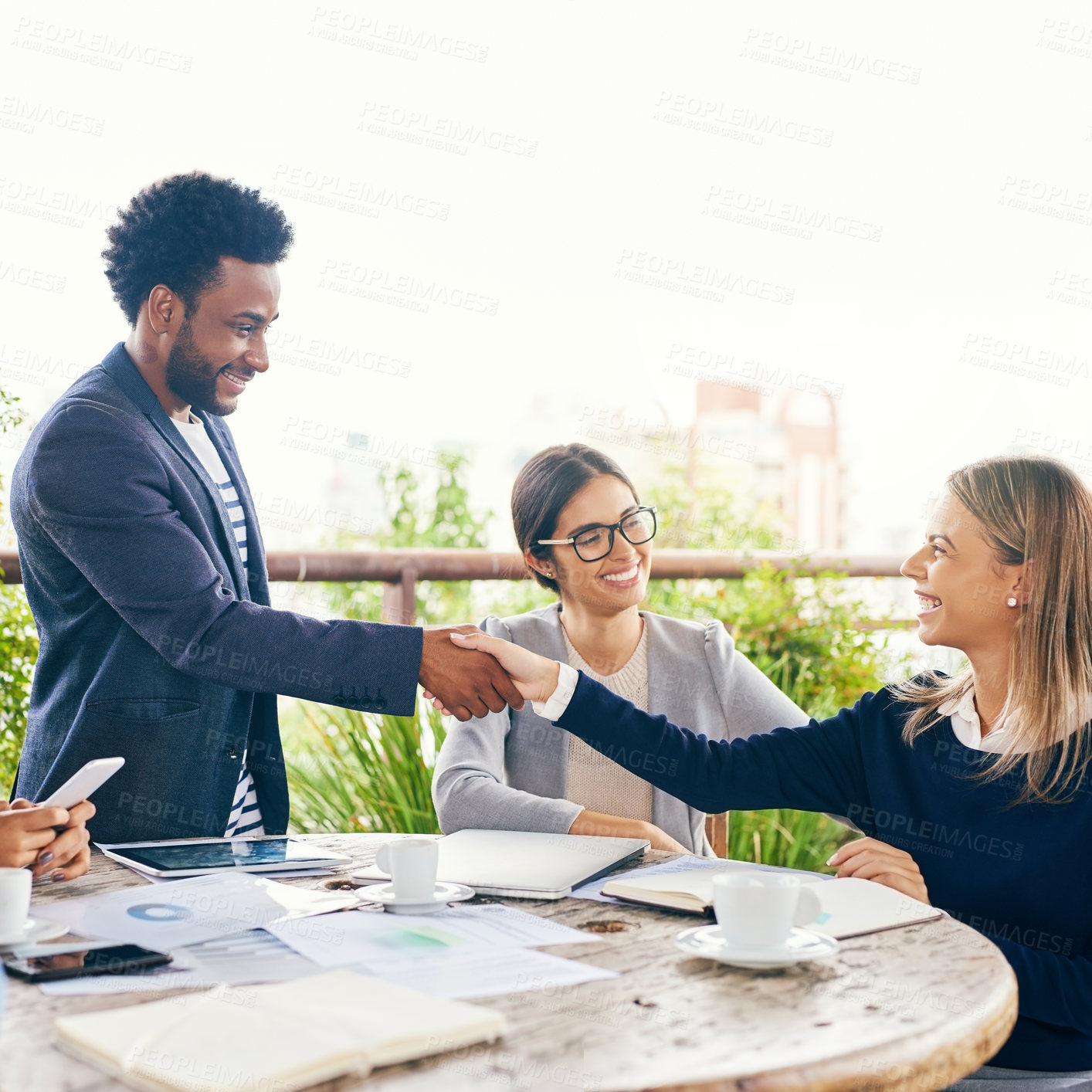 Buy stock photo Shot of businesspeople shaking hands during a meeting outdoors