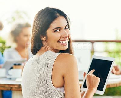 Buy stock photo Portrait of a young businesswoman using a digital tablet while having a meeting with her colleagues outdoors