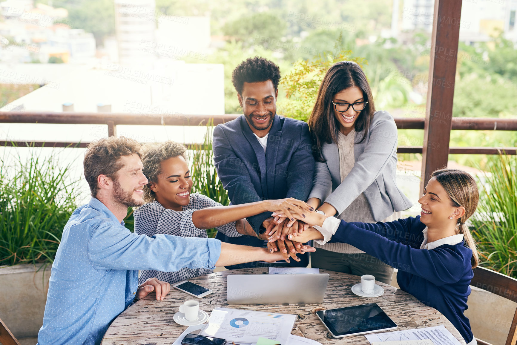 Buy stock photo Shot of a group of businesspeople joining their hands together in unity during a meeting outdoors