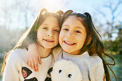 Buy stock photo Cropped shot of two adorable little girls holding each other outdoors