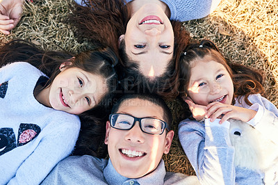 Buy stock photo High angle shot of a happy family spending time together outdoors