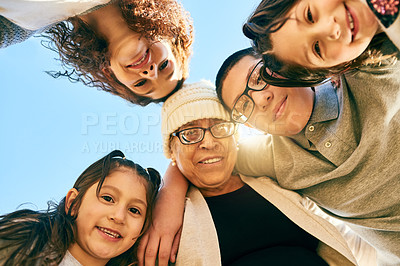 Buy stock photo Low angle shot of a multigenerational family spending time together outdoors