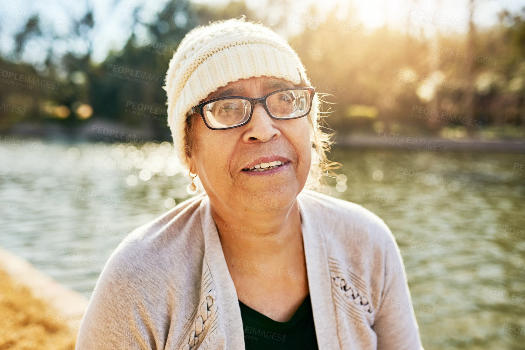 Buy stock photo Portrait of a senior woman standing next to a lake
