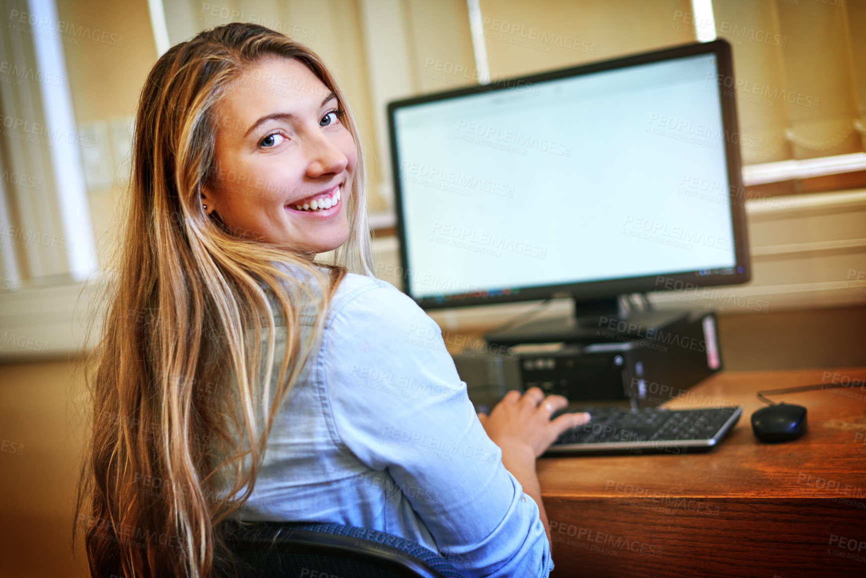 Buy stock photo Portrait of a university student working on a computer in the library at campus