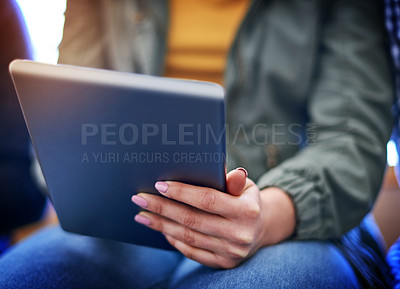 Buy stock photo Closeup shot of an unrecognizable university student using a digital tablet at campus