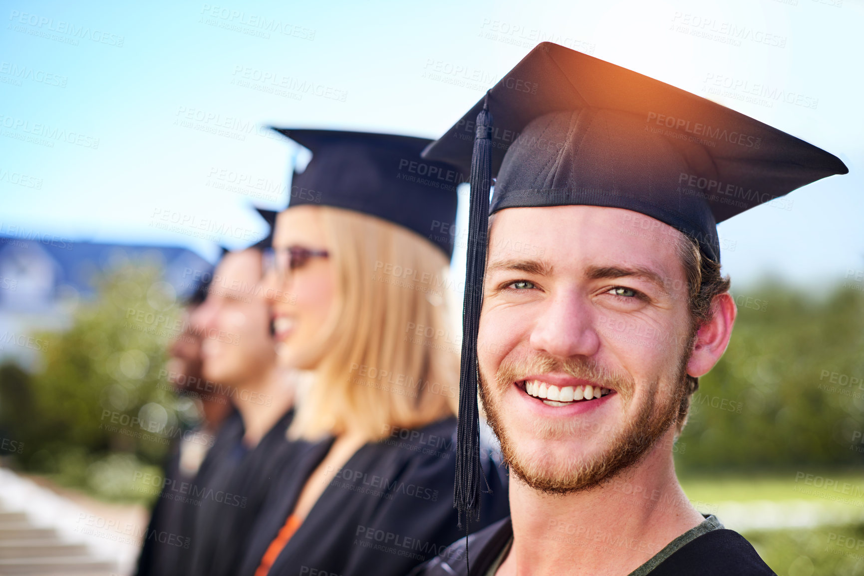 Buy stock photo Happy man, portrait or student with graduation at university for qualification, diploma or achievement. Young, male person or excited graduate with smile for scholarship degree or milestone on campus