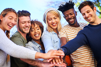 Buy stock photo Cropped shot of a group of diverse students huddled together with their hands piled on top of each other