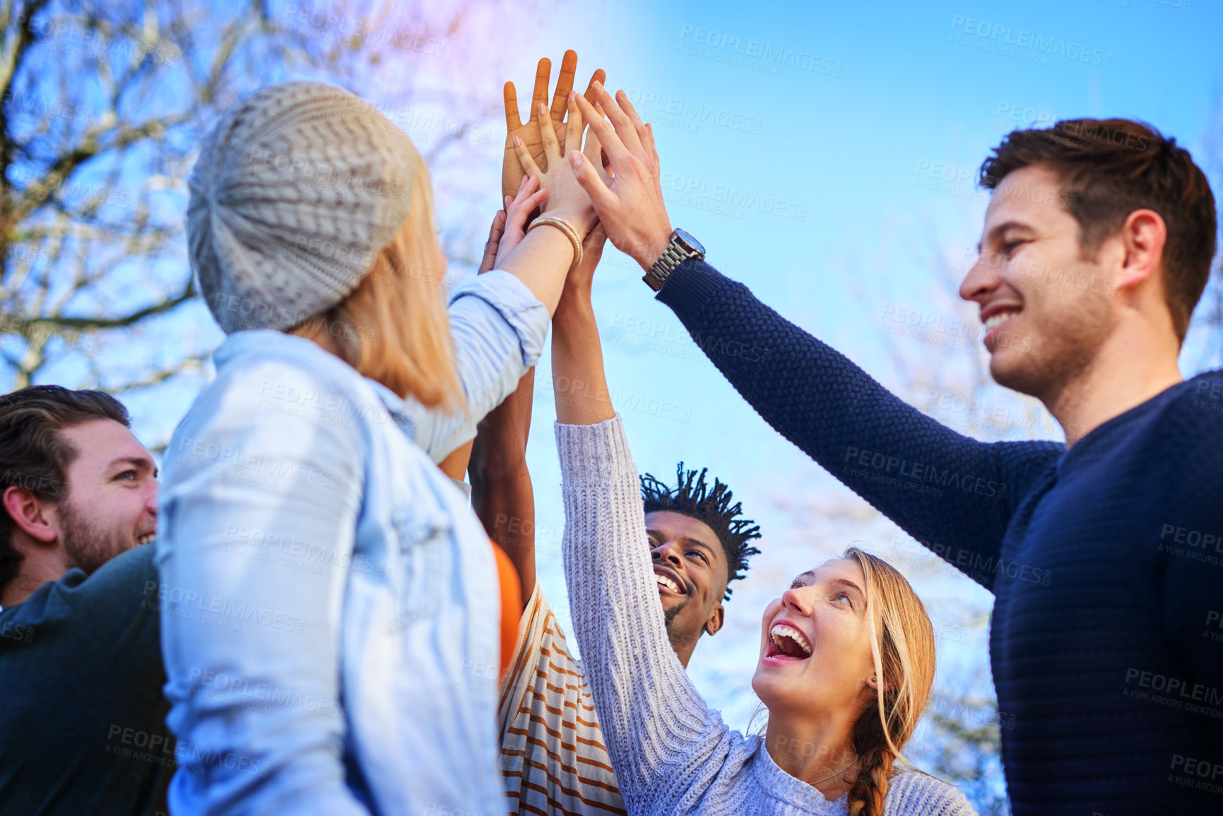 Buy stock photo Cropped shot of university students standing outside with their hands together