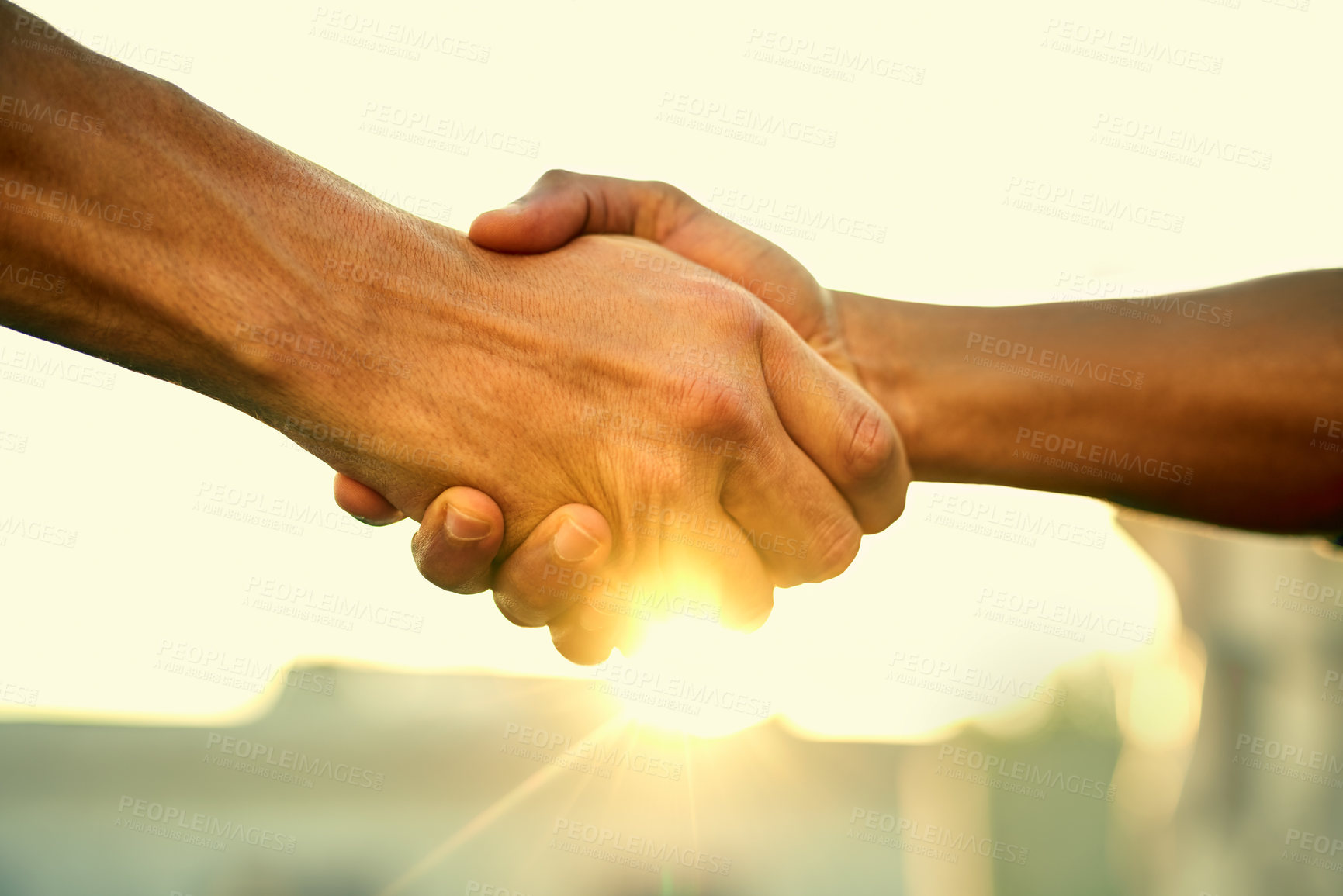 Buy stock photo Cropped shot of two people shaking hands outdoors