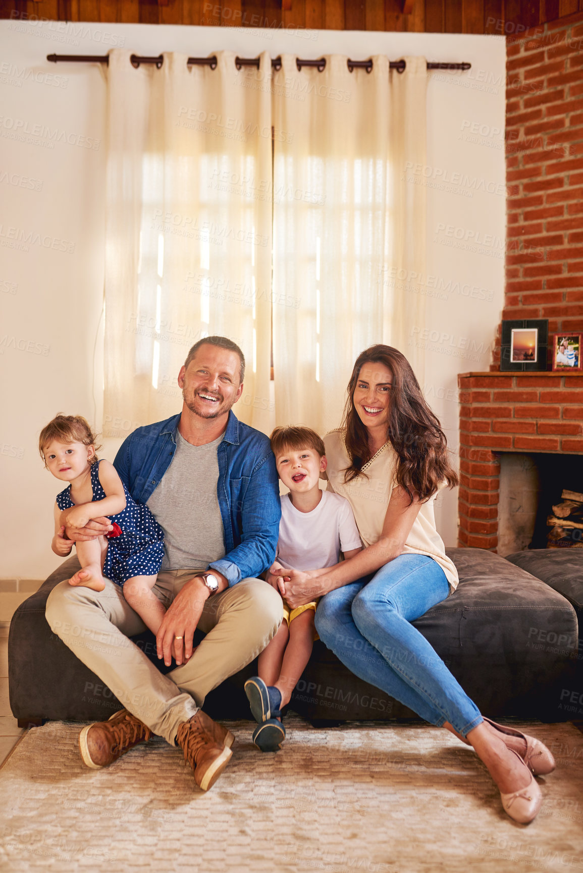 Buy stock photo Portrait, happy family and parents with kids in home for bonding, love and support. Smile, father and mother hug children in living room for connection, development and funny people laughing in UK