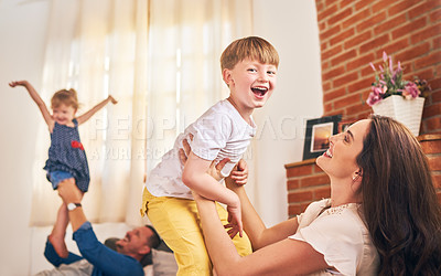 Buy stock photo Family, portrait and playing in home for relax, support and weekend with love, energy and flying. Parents, kids and people in living room for games, bonding and fun together with development on sofa