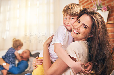 Buy stock photo Portrait of a happy little boy hugging his mother during family playtime at home