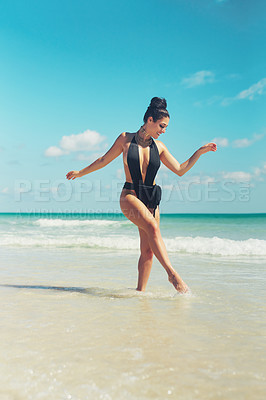 Buy stock photo Shot of a beautiful young woman in her bathing suit at the beach