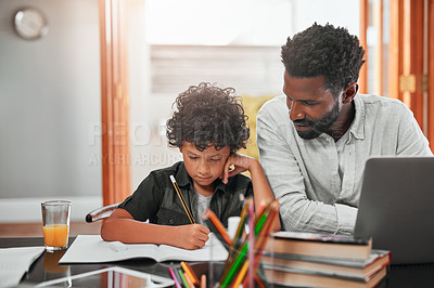 Buy stock photo Shot of a man helping his son with his homework
