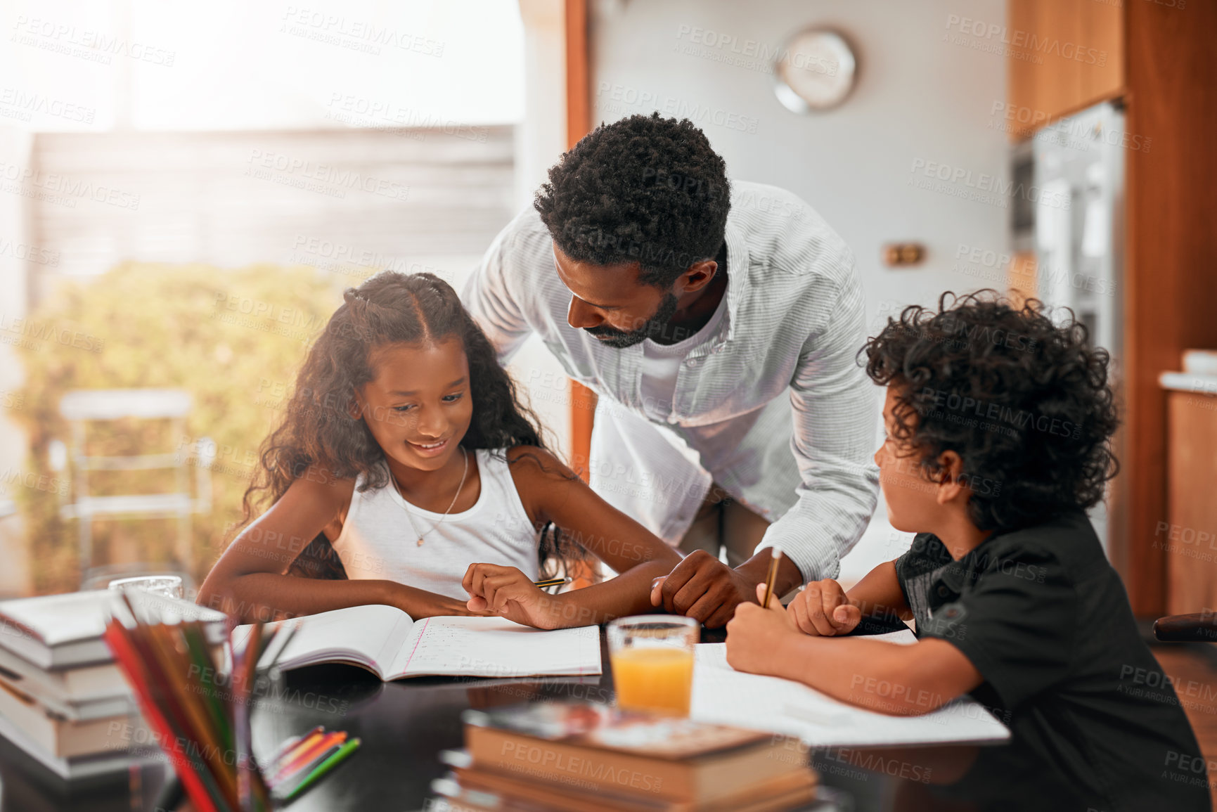 Buy stock photo Shot of a dad helping his children with their homework