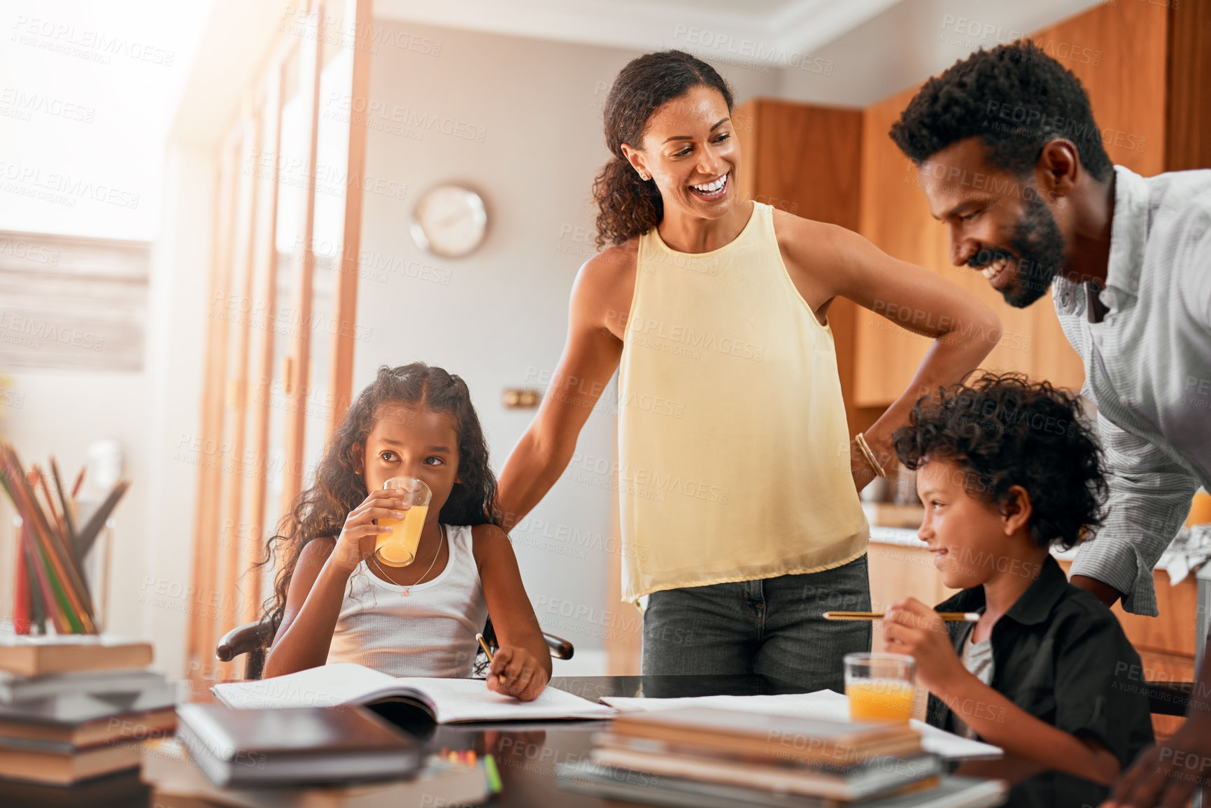 Buy stock photo Happy family, children and books with homework for learning, guidance or help on kitchen table. Mother, father and kids studying together for education, knowledge or childhood development at house