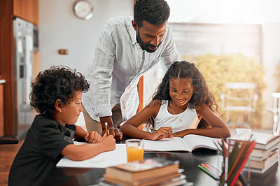 Buy stock photo Shot of a dad helping his children with their homework