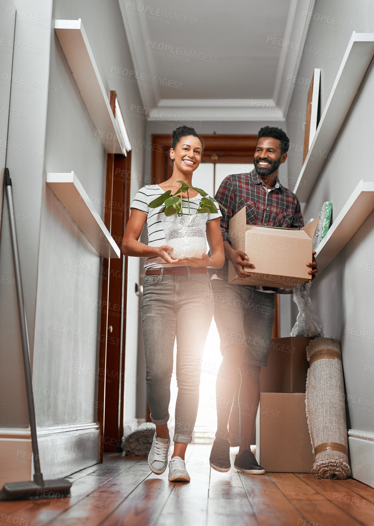Buy stock photo Shot of a young couple moving into a new home