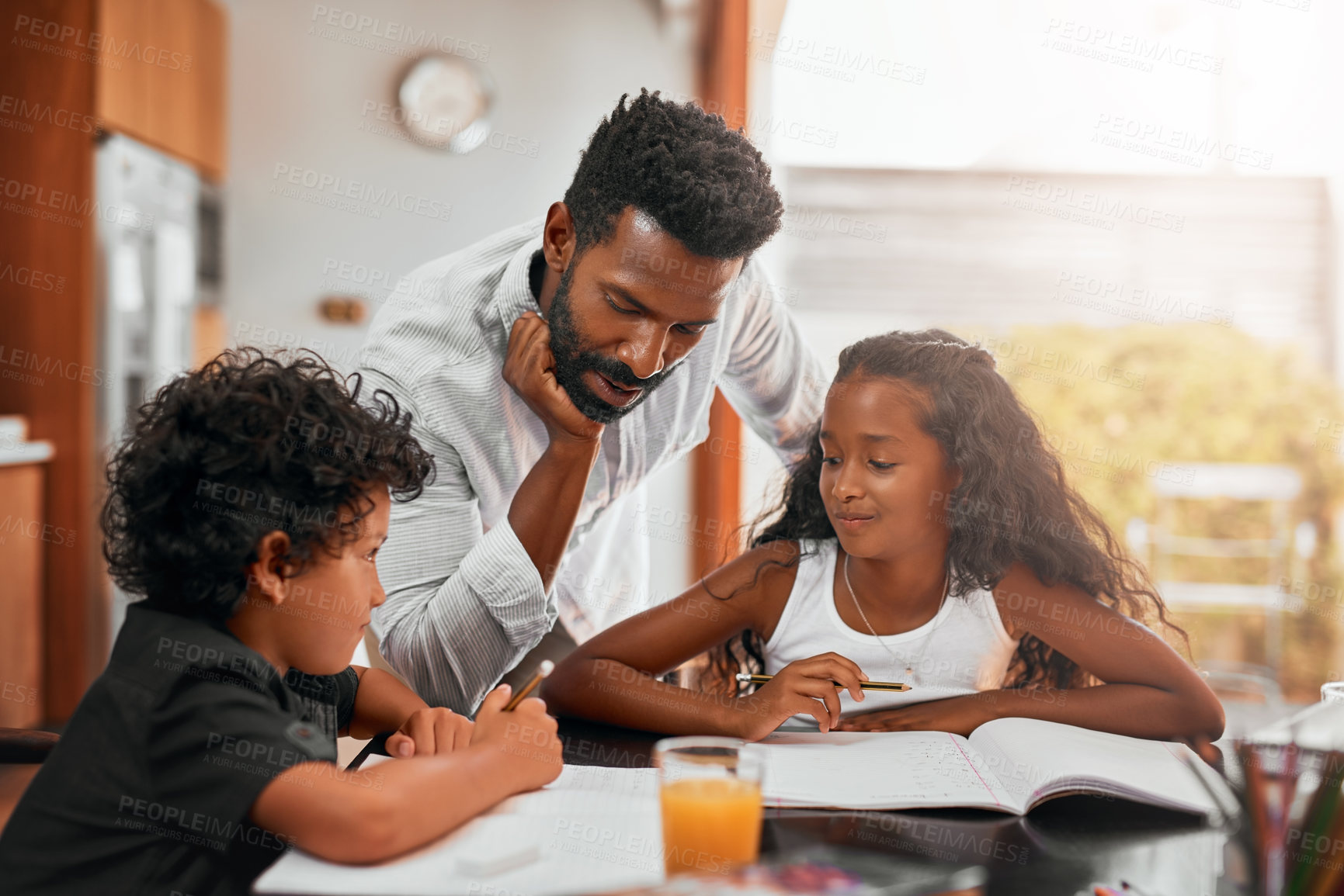 Buy stock photo Dad, children and books with homework for learning, guidance or help on kitchen table. Happy father, kids or siblings studying together for education, knowledge or childhood development at house