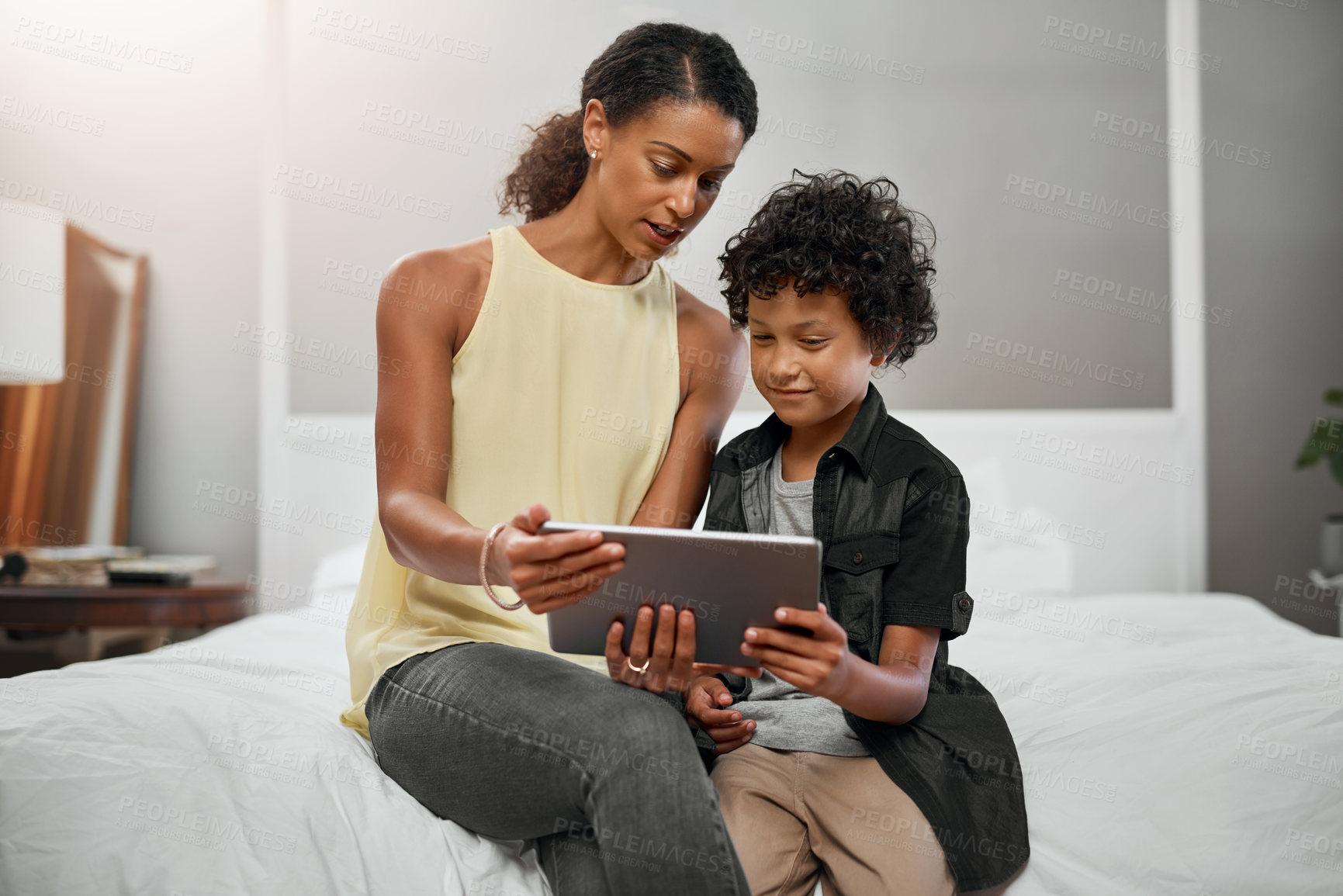 Buy stock photo Relax, mom and boy on bed with tablet for movie streaming, reading and morning bonding together in happy home. Smile, mother and child in bedroom with digital app for ebook, video or online games