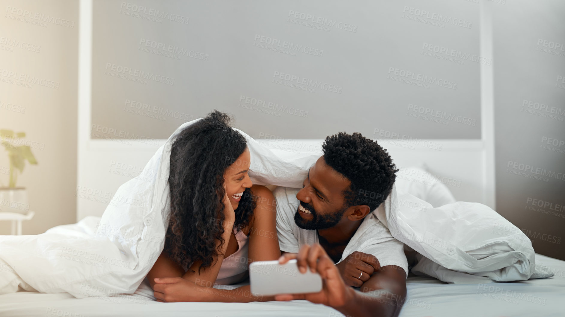 Buy stock photo Selfie, bedroom and couple with smile, love and relax with comfort, bonding together and memory. House, mobile user and man with woman, happiness and joy with weekend break, morning and relationship