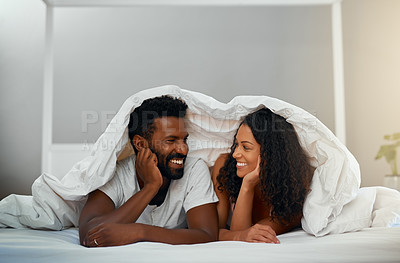 Buy stock photo Cropped shot of a young attractive couple in bed at home