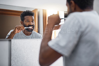 Buy stock photo Black man, toothbrush and brushing teeth with mirror for dental care, hygiene or grooming at home. Young African, male person or cleaning teeth with bristle for gum, mouth or oral routine at house