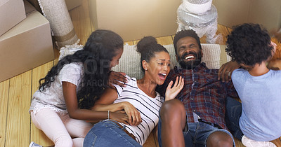 Buy stock photo Cropped shot of a young family taking a break in their new home