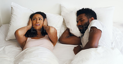 Buy stock photo Cropped shot of a beautiful wife annoyed by her handsome husbands snoring in bed at home