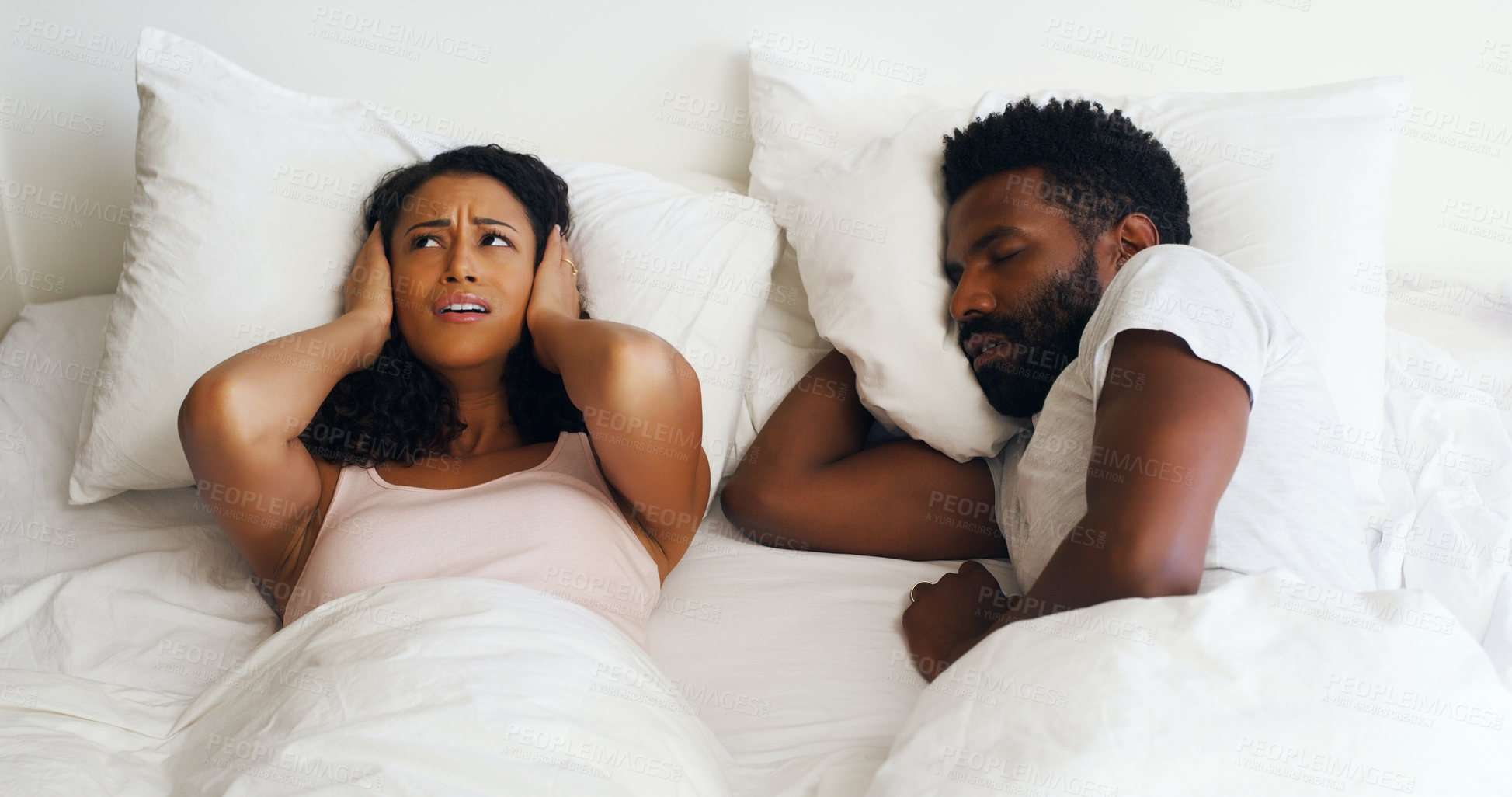 Buy stock photo Cropped shot of a beautiful wife annoyed by her handsome husbands snoring in bed at home