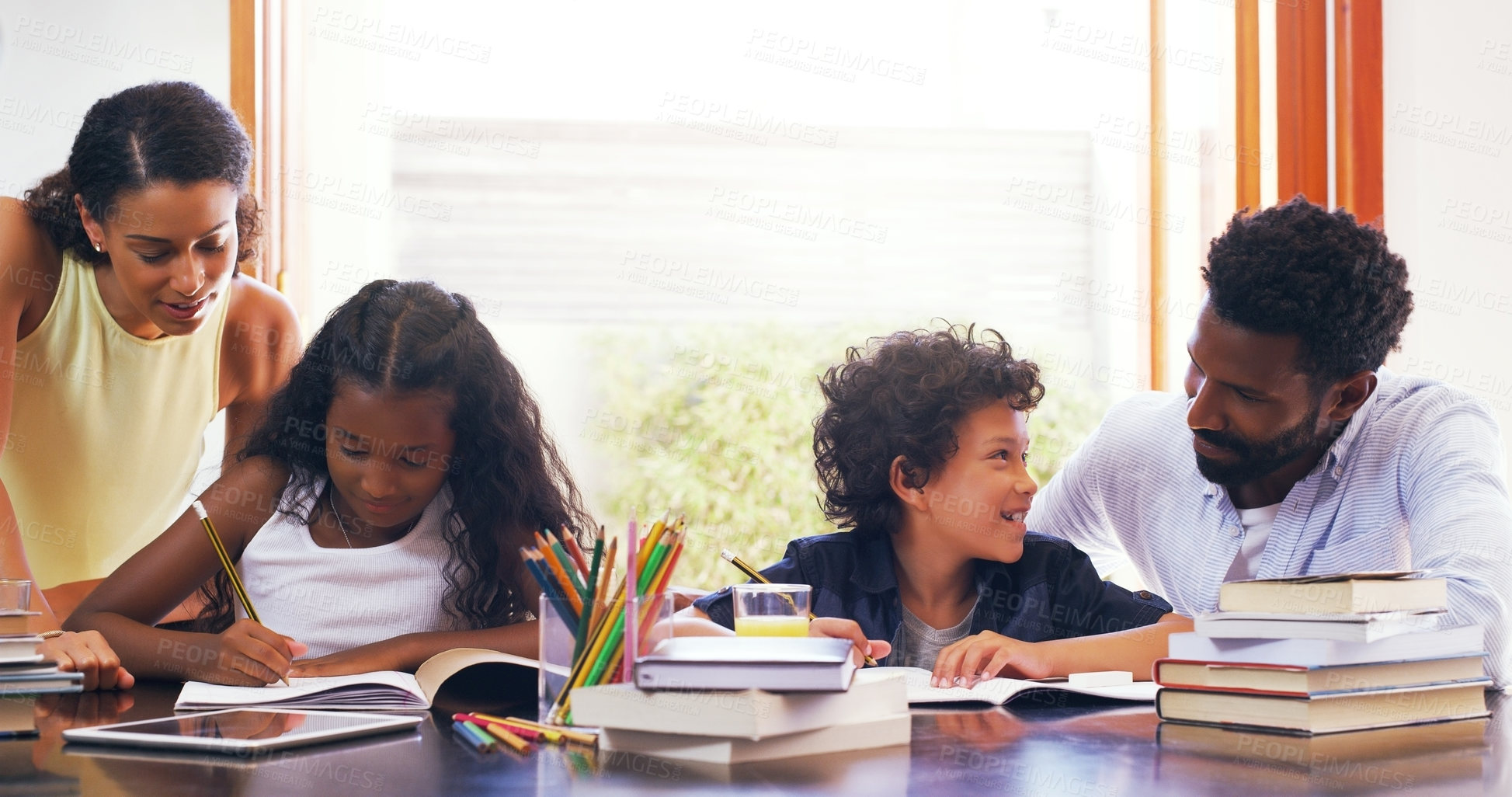 Buy stock photo Cropped shot of parents helping their two children with their schoolwork at home