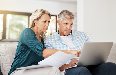 Buy stock photo Cropped shot of a mature couple doing their household budget at home