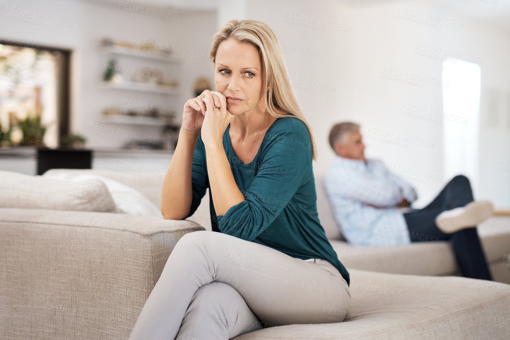 Buy stock photo Cropped shot of a mature woman looking despondent after having a fight with her husband at home