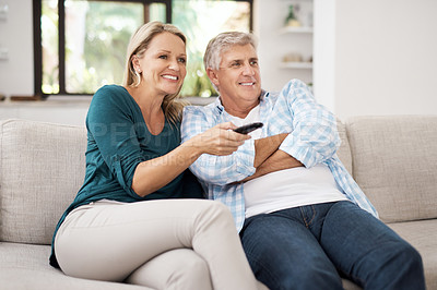 Buy stock photo Cropped shot of an affectionate mature couple watching television together at home