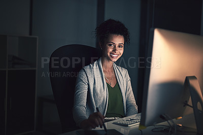 Buy stock photo Portrait of a young businesswoman working late on a computer in an office