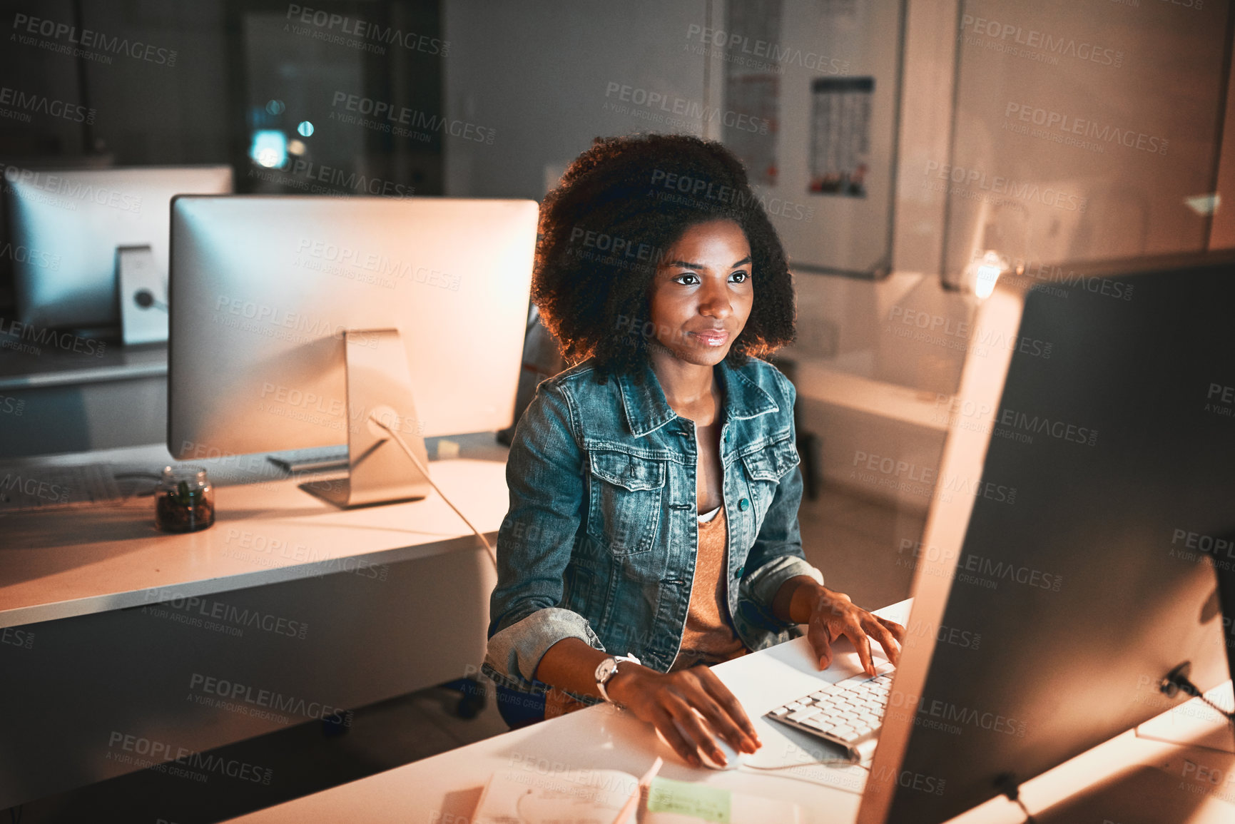 Buy stock photo High angle shot of an attractive young female designer working on her computer in the office