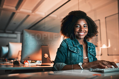 Buy stock photo Low angle portrait of an attractive young female designer working on her computer in the office