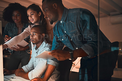 Buy stock photo Cropped shot of a group of young designers working together on a computer in their office