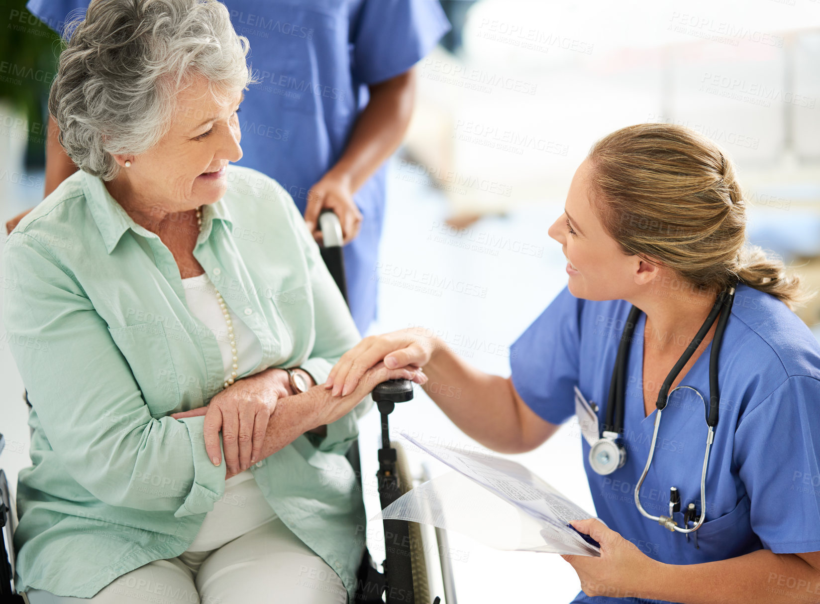 Buy stock photo Cropped shot of an attractive female nurse discussing treatments with her wheelchair-bound senior patient in the hospital